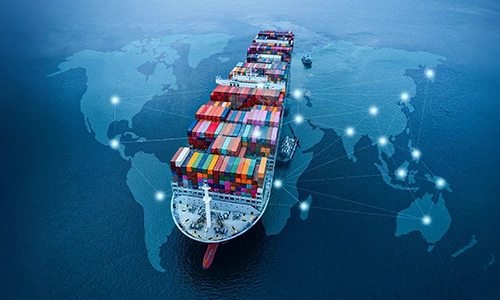 Aerial view of a loaded cargo ship overlaid with a digital global map network.