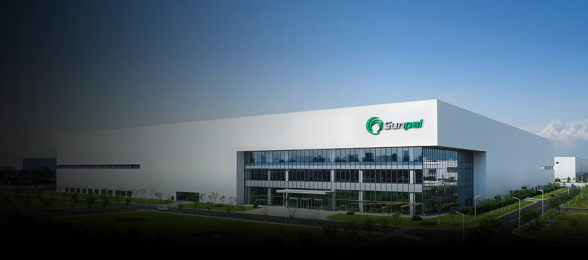Modern white industrial facility building displaying the Sunpal logo on its glass facade under a clear blue sky.