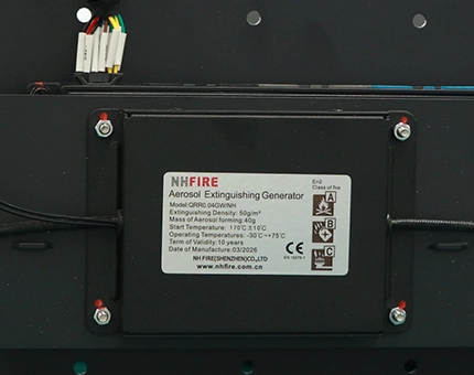 NH FIRE aerosol fire extinguishing generator mounted on a black panel inside a battery storage enclosure.