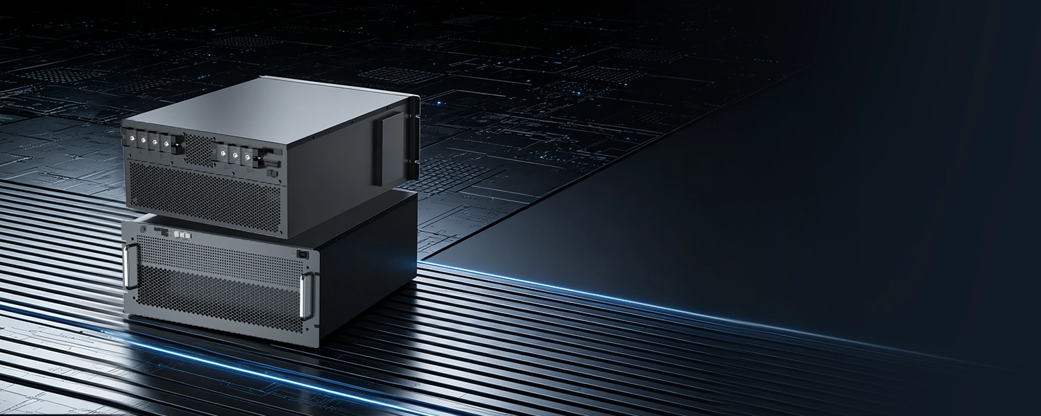 Two stacked black rack-mounted air-conditioning units with front ventilation grilles set on a metallic surface.
