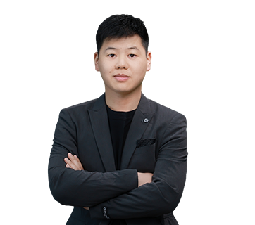Professional portrait of Alvin Chen, Sales Director – Europe, standing with arms folded in a dark blazer against a plain white background.