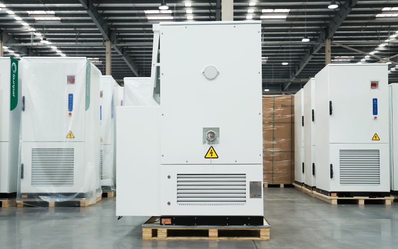 Rear view of the white ECO-B261LP-2H energy storage cabinet showing the back enclosure, high-voltage warning label, and lower heat dissipation ventilation louvers.