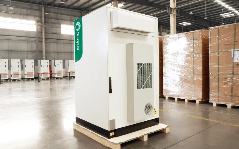 Rear side view of the Sunpal ECO-E101WX energy storage cabinet with closed door, showing the integrated outdoor HVAC cooling system in a warehouse setting.