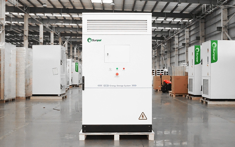 Front view of the Sunpal ECO-E101WX commercial energy storage cabinet sitting on a wooden pallet inside a manufacturing warehouse facility.