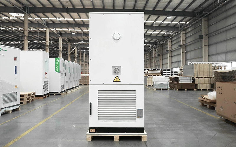 Rear view of the closed Sunpal ECO-E261LP-2A energy storage cabinet featuring ventilation louvers and safety warning labels inside a factory facility.