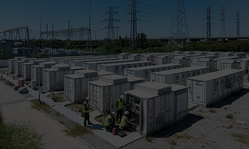 Engineers commissioning a large-scale containerized energy storage system at a power station.
