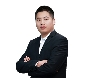 Professional portrait of Jack Dong, Logistics & Delivery Director, standing with arms folded in a dark suit jacket against a plain white background.