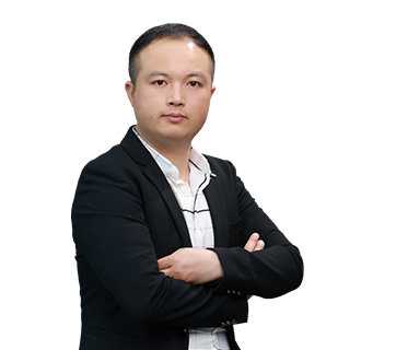 Professional portrait of Technical Director Qerry Xie standing with arms crossed, wearing a black blazer and patterned shirt against a plain white background.