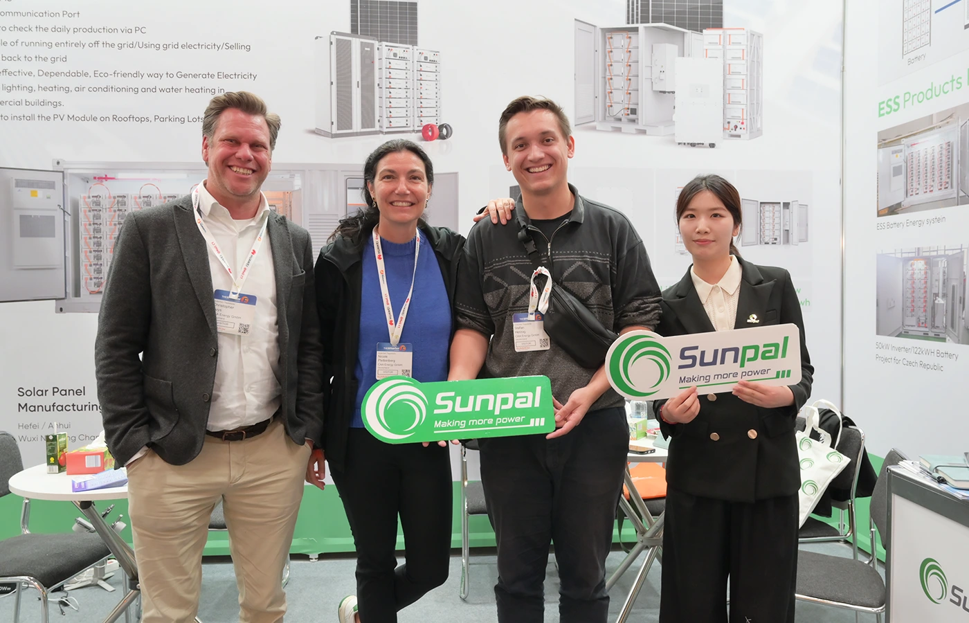 Diverse Sunpal energy storage team members holding green brand signs at a commercial ESS industry exhibition.