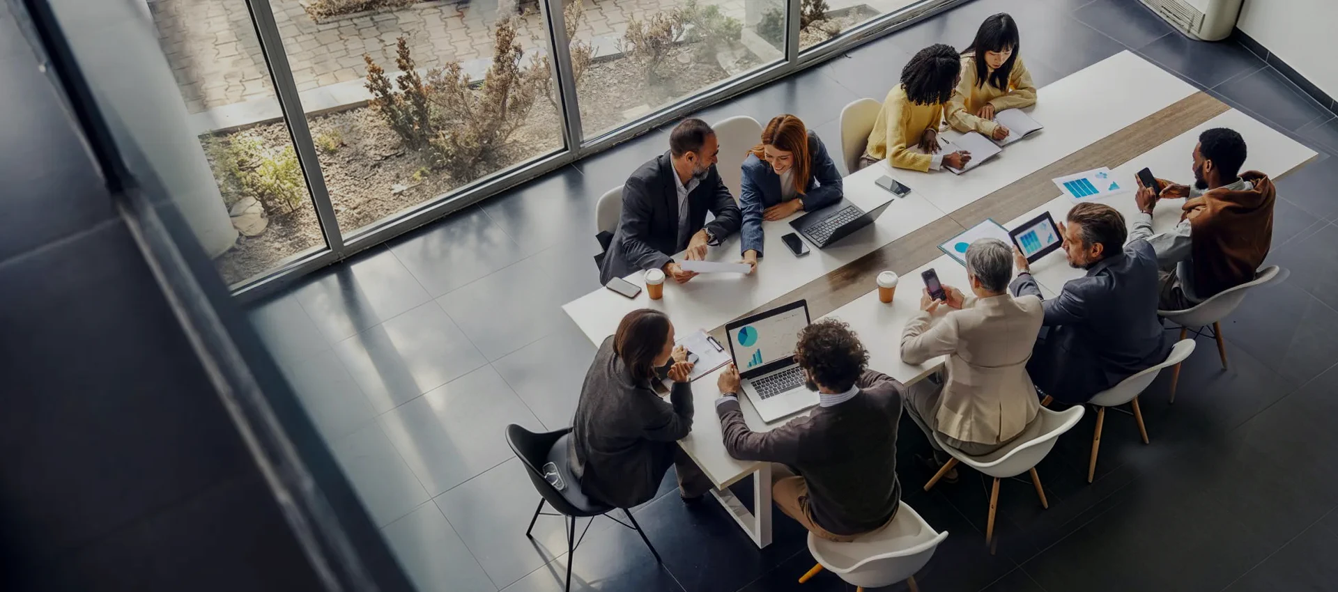 Diverse team of Sunpal energy storage experts analyzing market insights and data around a conference table in a modern office.